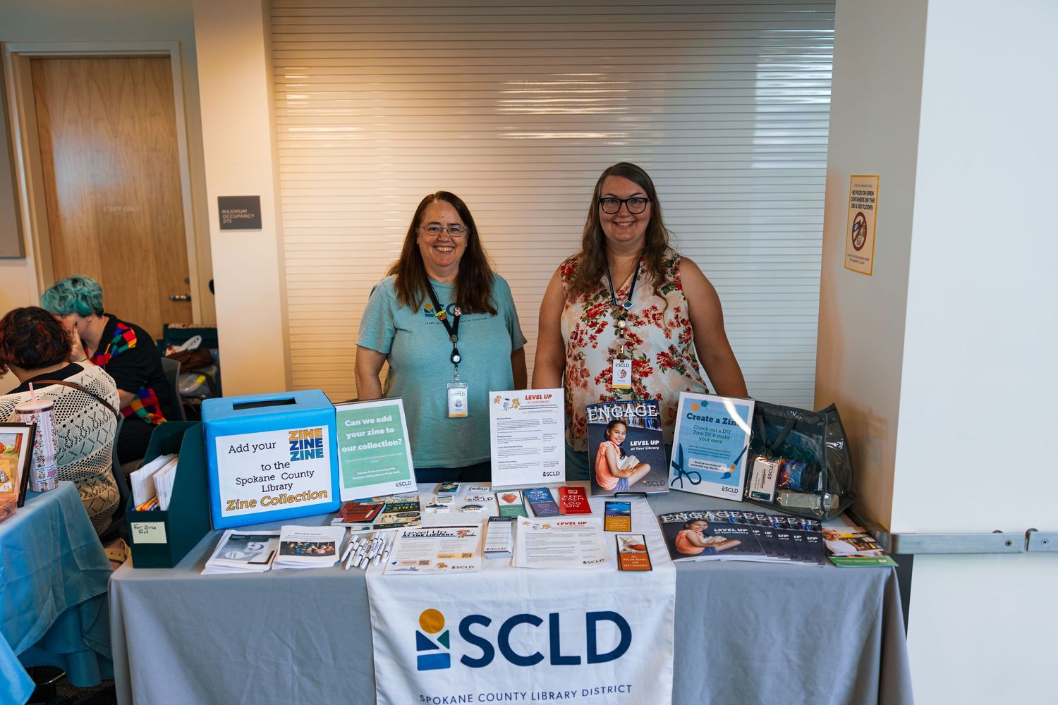 Information tables and displays set up at a conference or event with banners and promotional materials.
