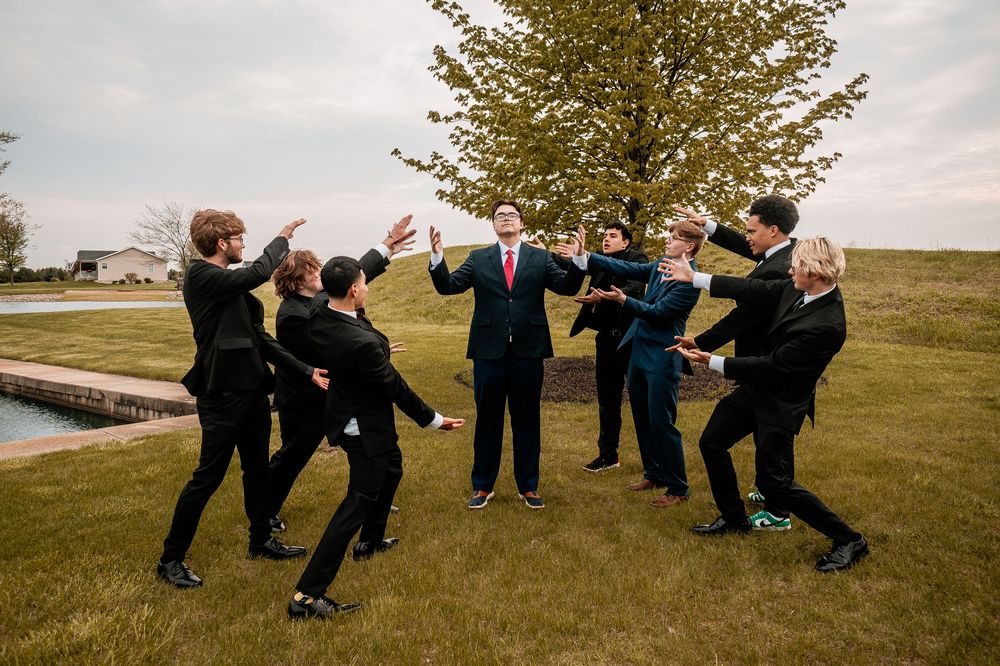 Wedding party members playfully pose together in a sequence of candid outdoor photos on a grassy field.