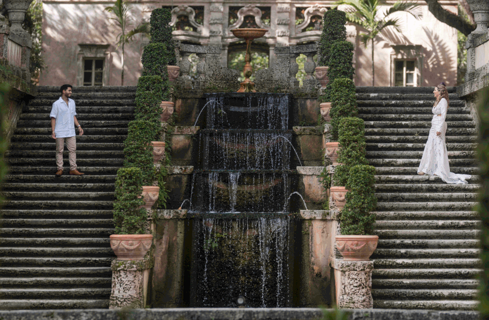Couple embracing on staircase during engagement session at Vizcaya Miami