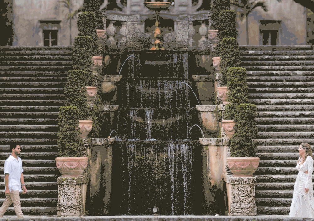 Couple embracing on staircase during engagement session at Vizcaya Miami