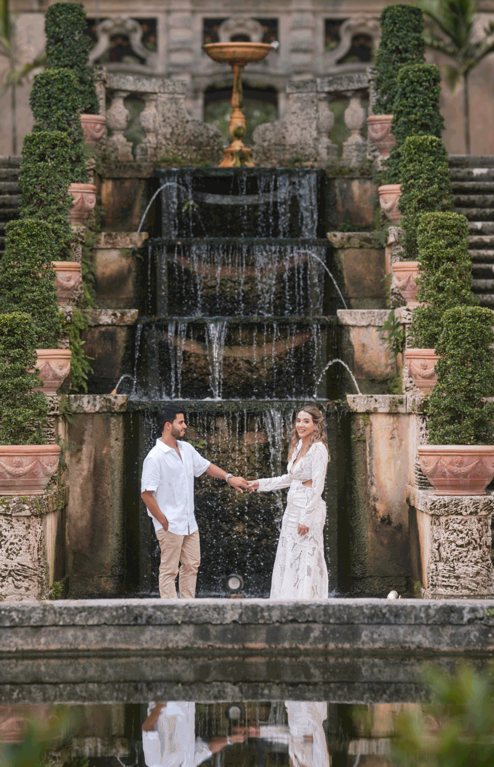 Couple posing on grand staircase during engagement photos at Vizcaya Museum