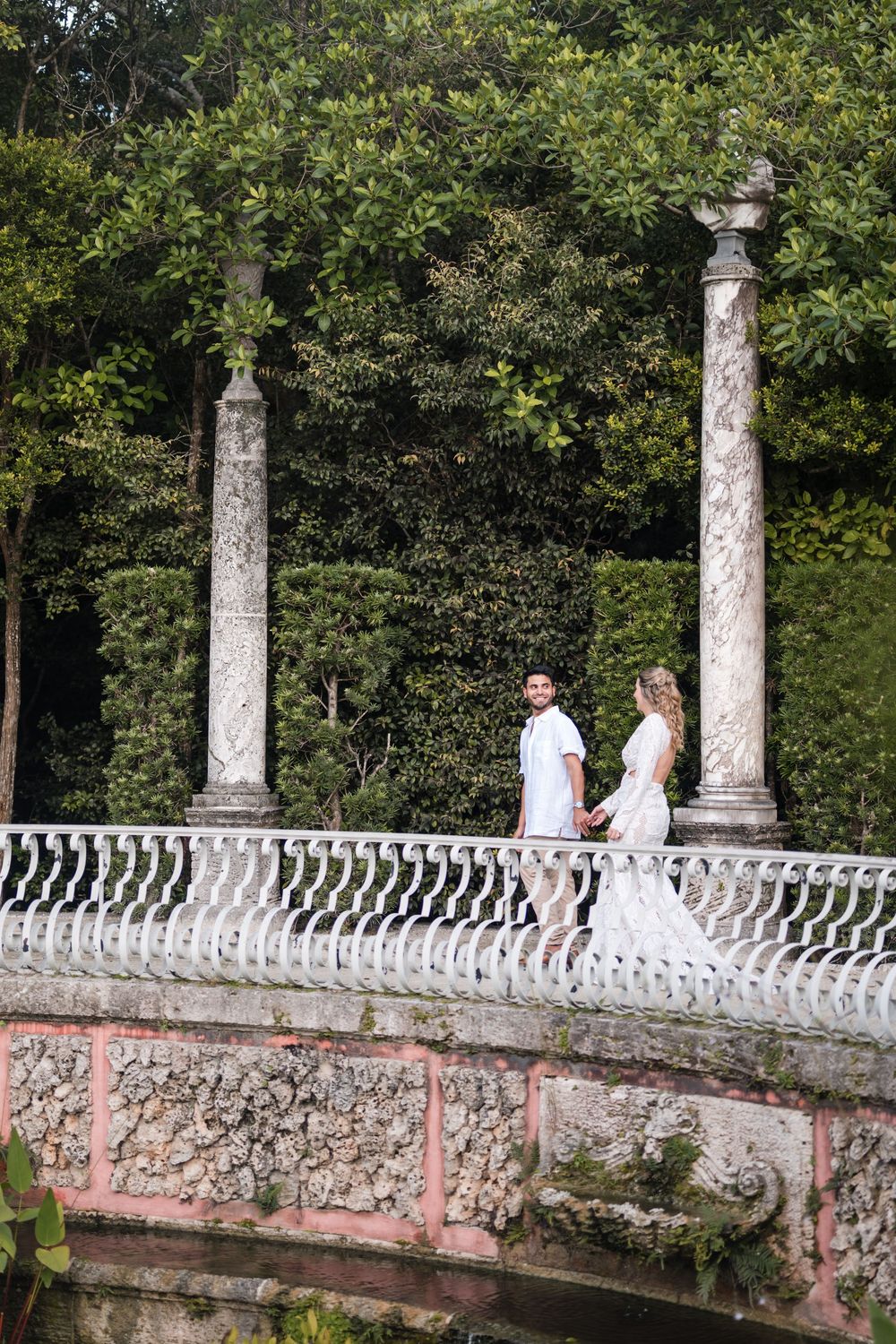 Couple reflected in water during engagement session at Vizcaya Miami