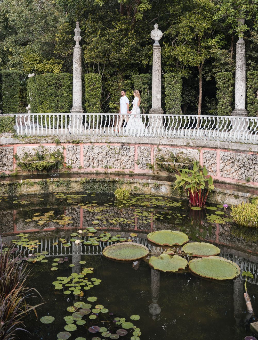 Couple reflected in water during engagement session at Vizcaya Miami