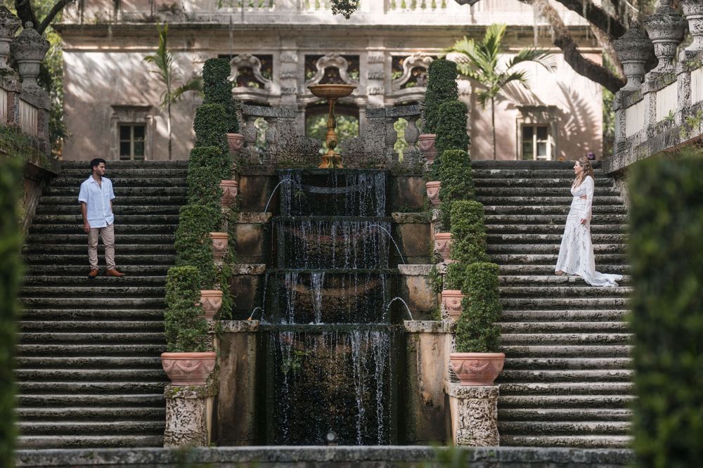 Couple standing together in front of waterfall staircase at Vizcaya Miami