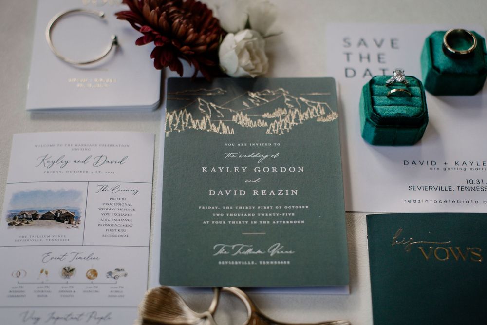 Wedding stationery suite featuring emerald green and white invitations with elegant typography.