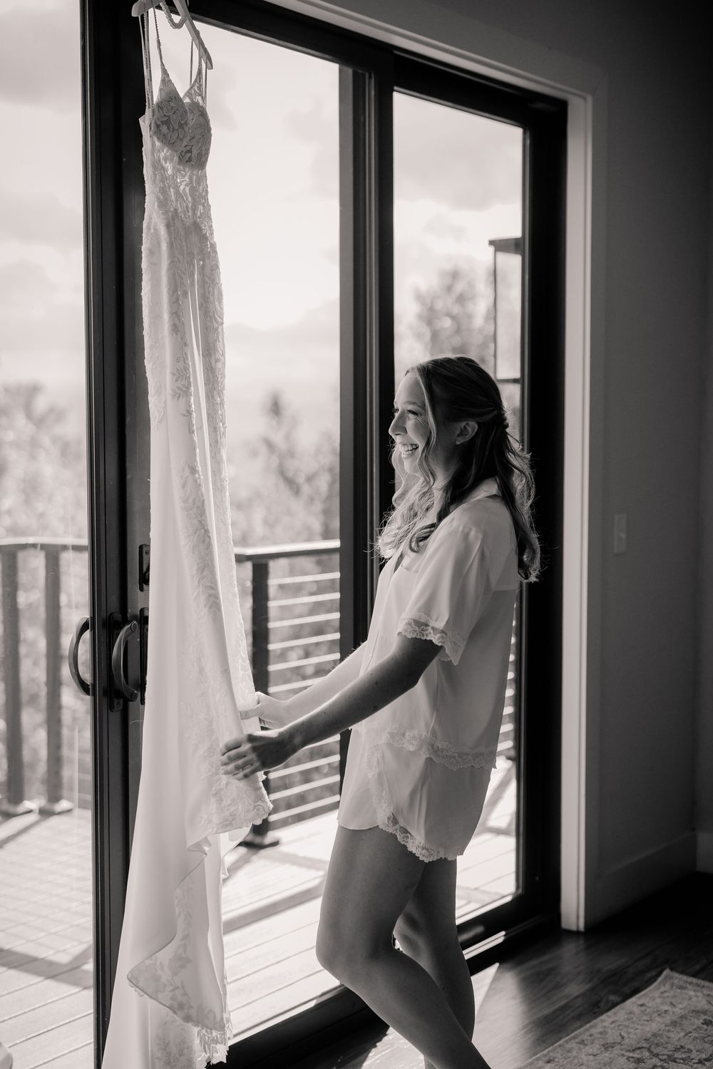 Silhouetted figures stand near large windows with natural light streaming in.