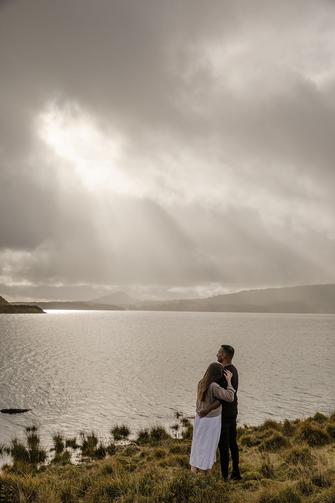 Couple embracing each other during moody winter elopement in Connemara