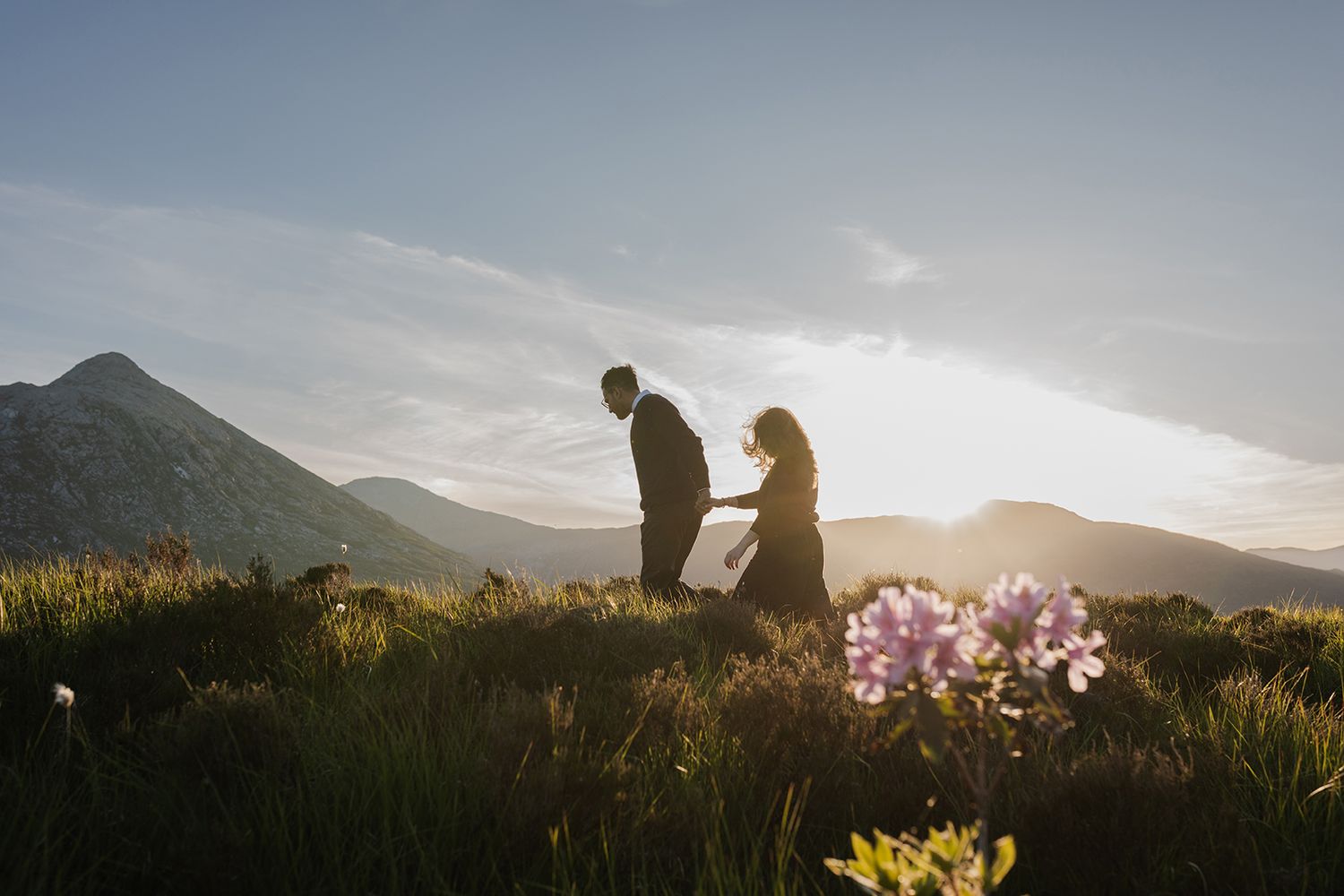 Adventure couple in wildflower meadow in Connemara during spring