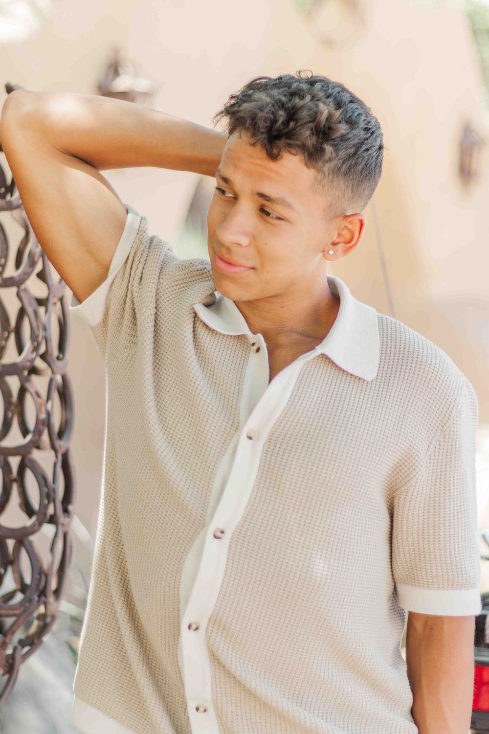 Portrait series showing casual poses in beige ribbed polo shirt outdoors.