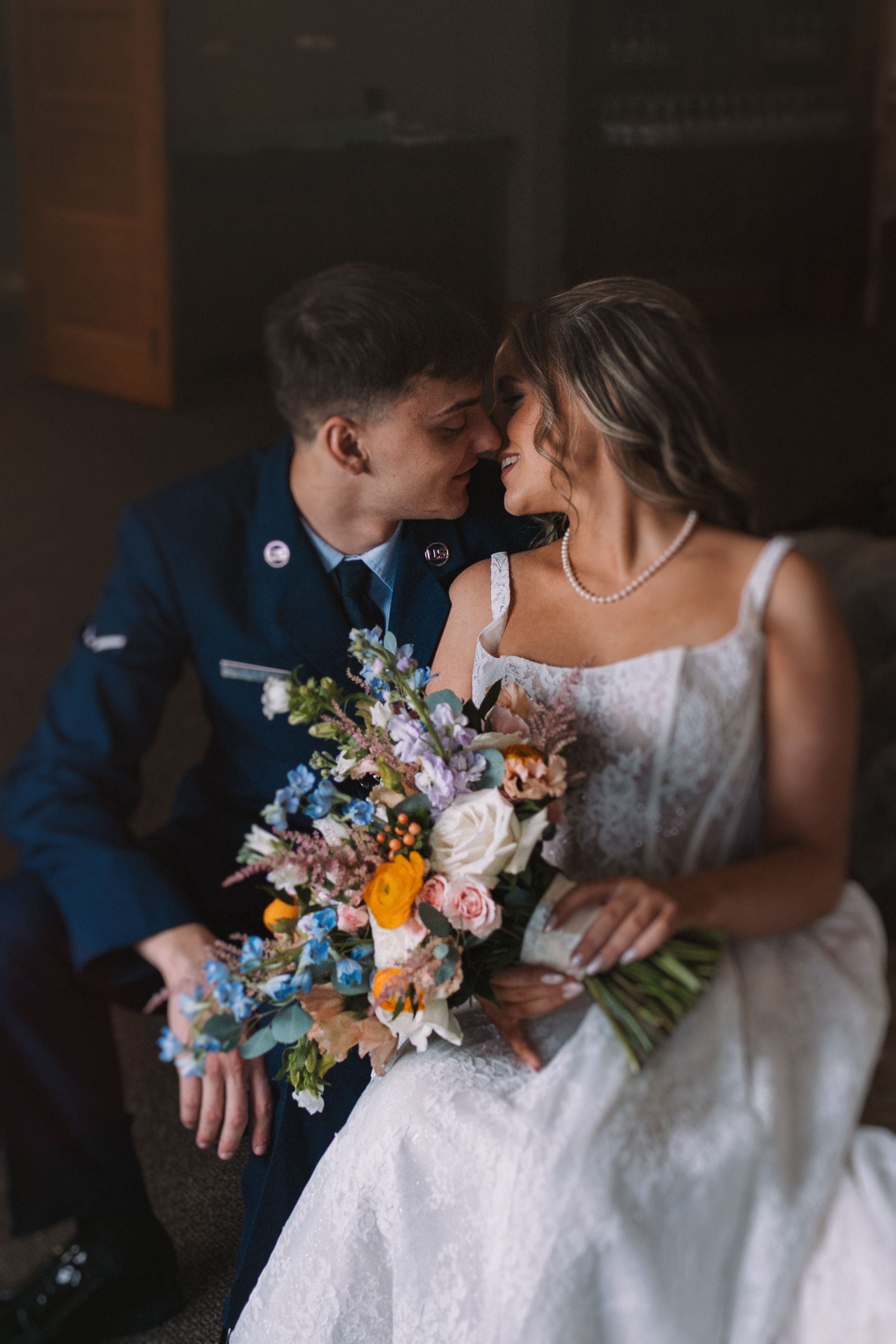 Intimate wedding photos showing tender moments with a colorful bouquet between poses.