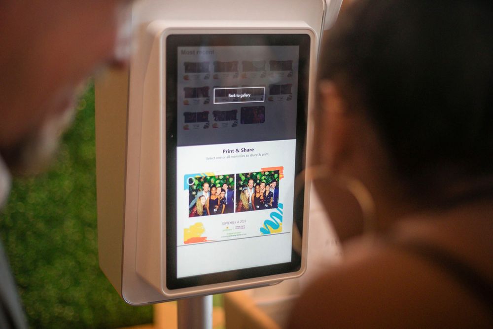 A tablet device mounted on a wall displays a digital menu or entertainment interface with colorful icons.