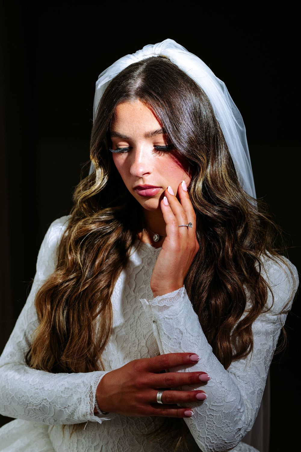 Artistic bridal portrait series showing dramatic poses in a white lace gown with flowing veil.