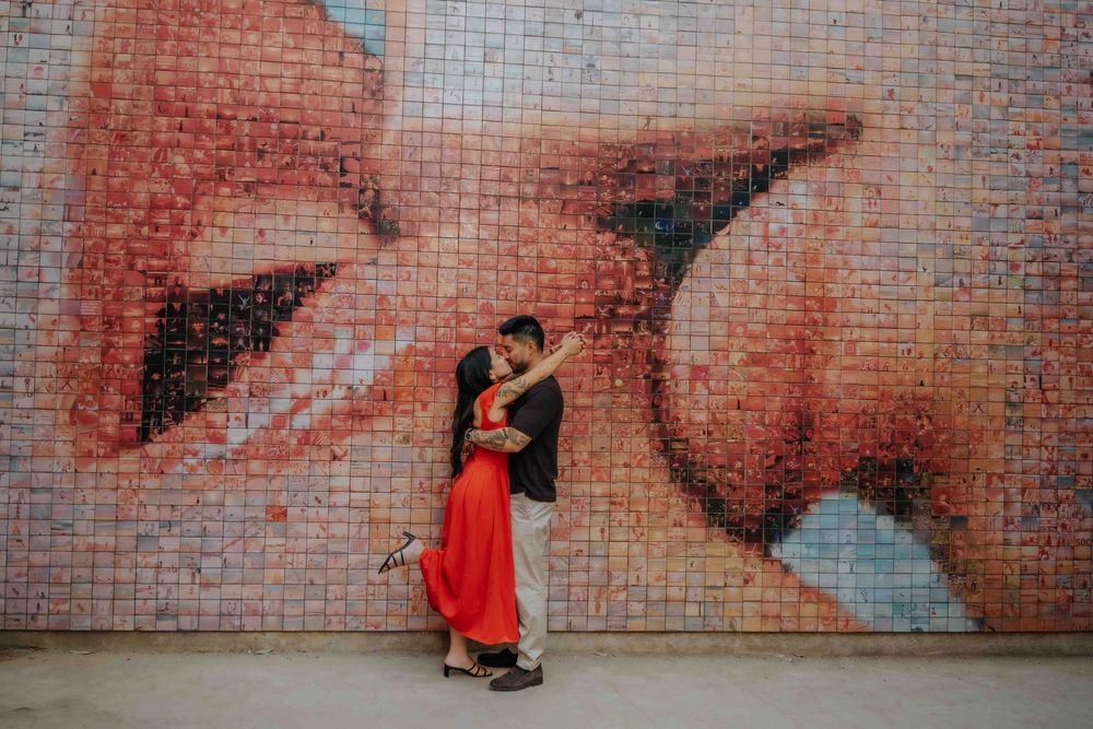 Wide shot of couple in front of historic architecture in Barcelona Old City for engagement announcement.