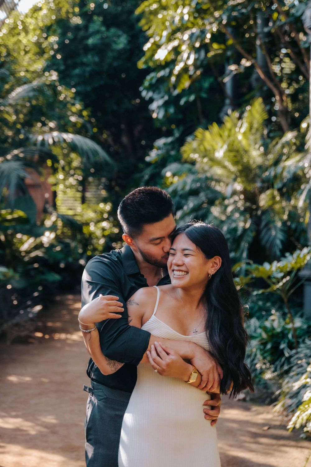 Joyful couple running and laughing in Ciutadella Park candid Barcelona photographer.