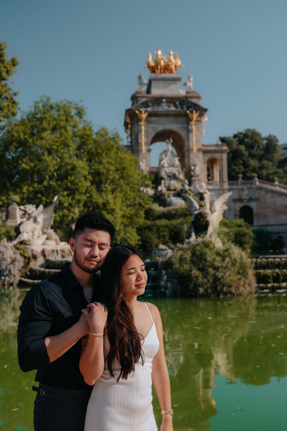 Joyful couple running and laughing in Ciutadella Park candid Barcelona photographer.