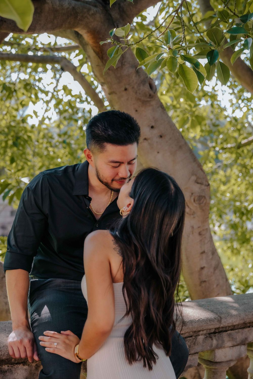 Couple showing off outfit changes during a stylish summer engagement session.