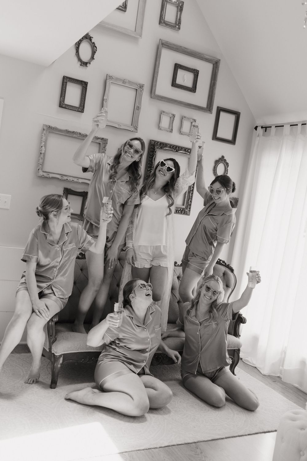 A sequence of five black and white photos showing progressive movement poses on a light floor against a wall with frames.