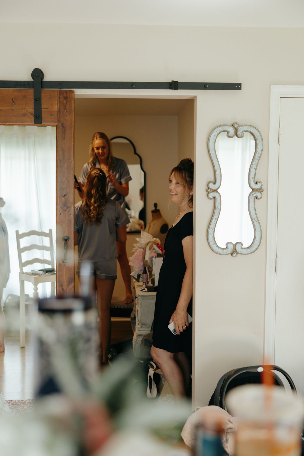 Behind the scenes photo shoot preparation in a bright interior space with rustic barn door.