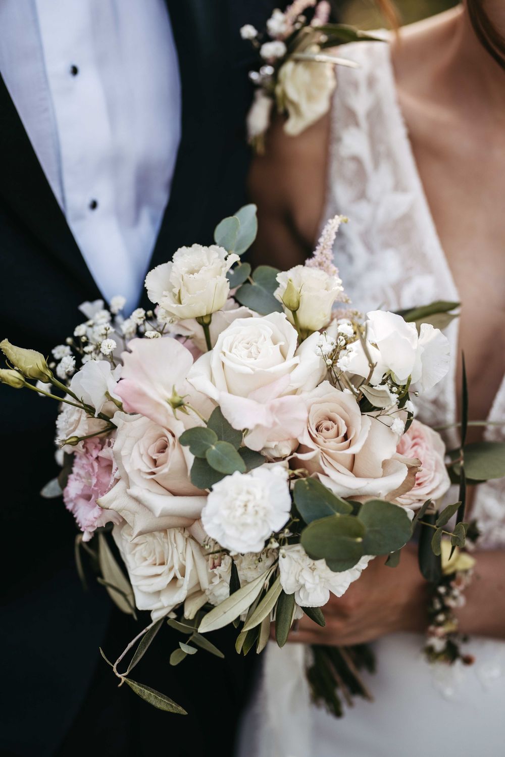 A series of elegant wedding bouquets featuring soft pink and white roses with delicate greenery against a dark background.