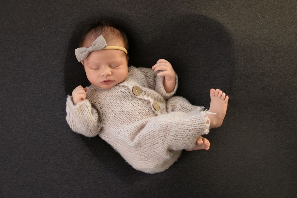 Newborn photography session in Salt Lake City with neutral tones and natural posing
