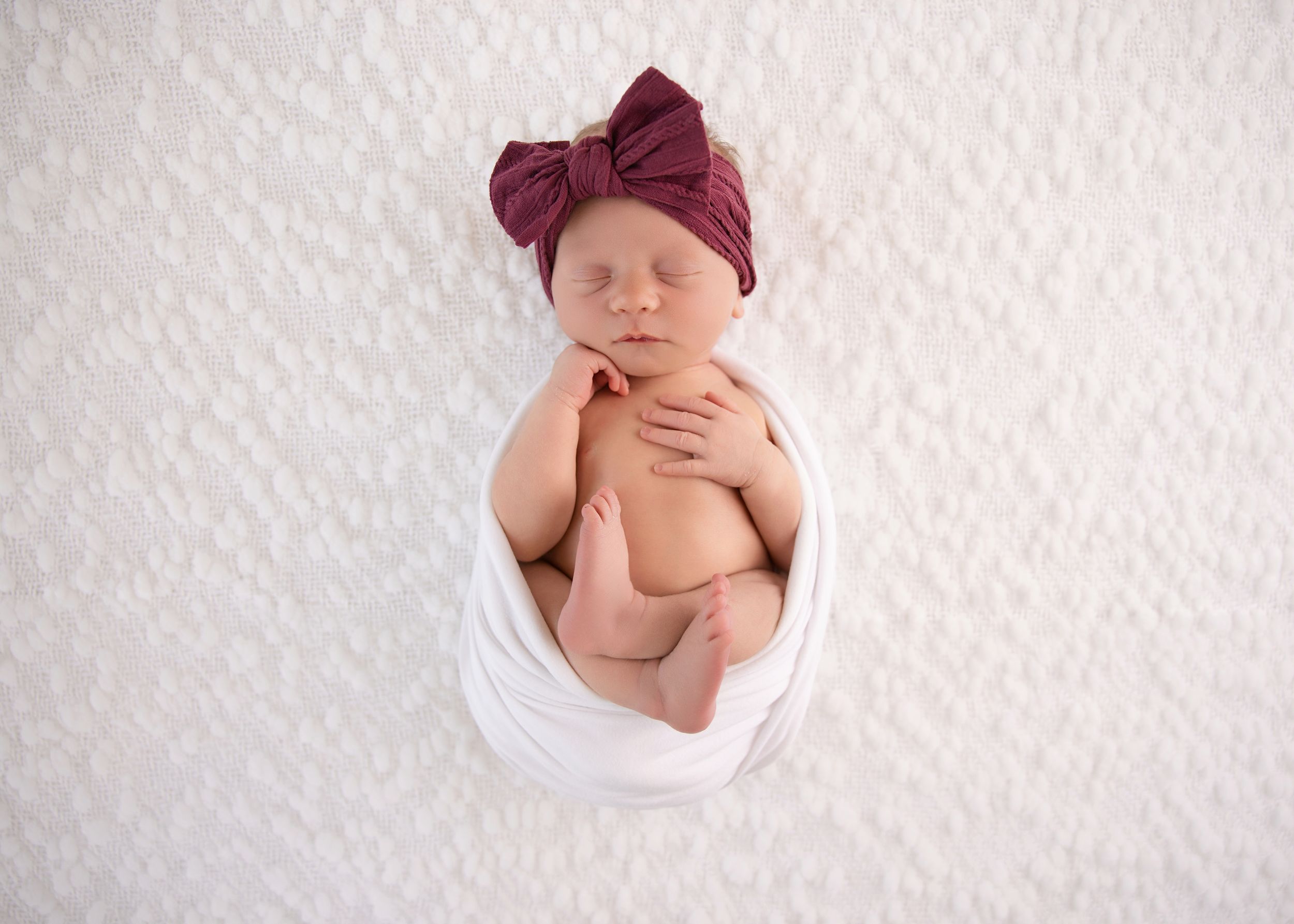 Professional newborn photographer in Salt Lake City photographing a sleeping baby