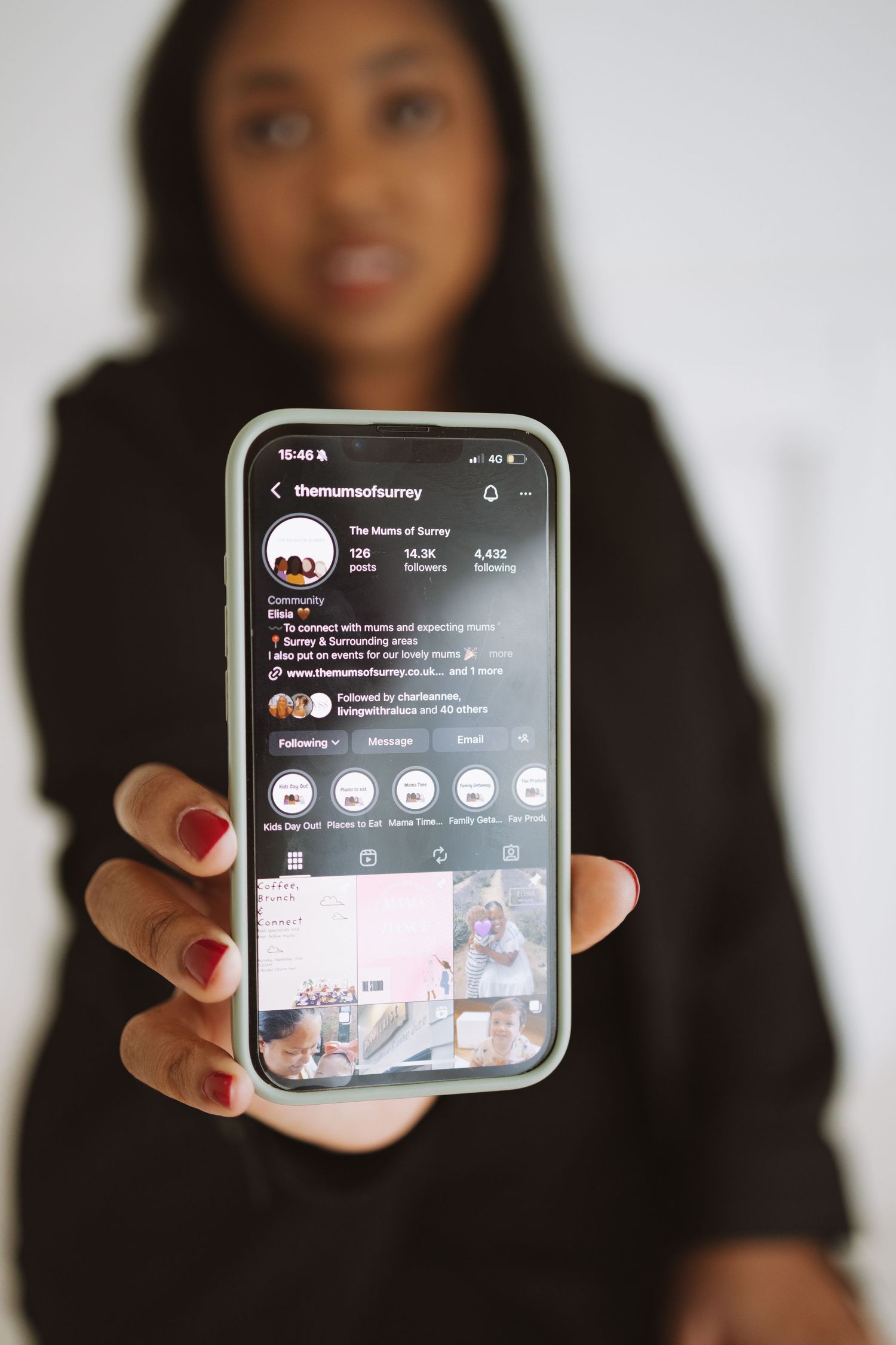 A person in a black sweater holds up a smartphone displaying a social media interface in multiple similar poses.