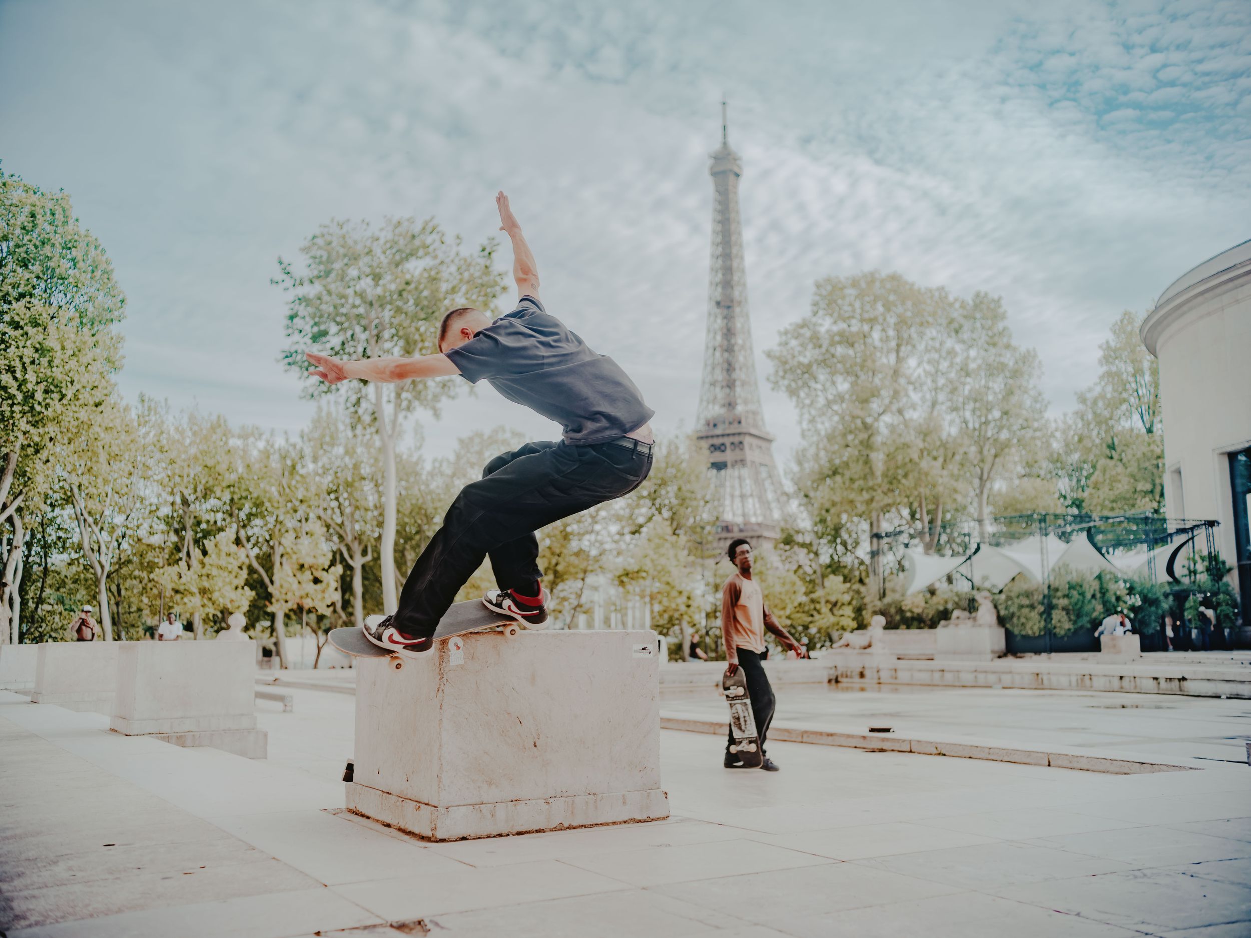Skaters outside Place du Trocadéro with the eiffel tower in the background, Paris, France. 2024