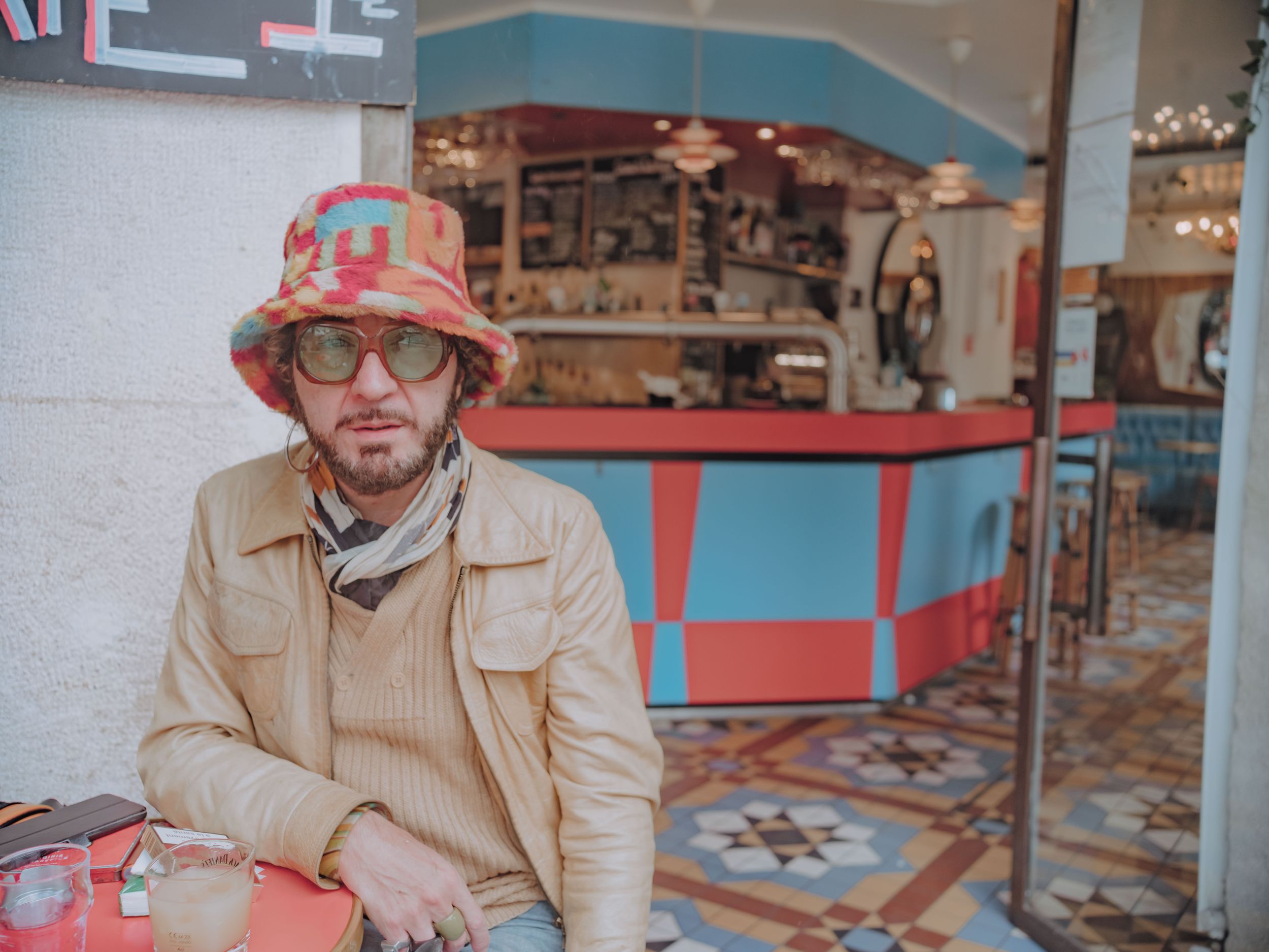 Fashionista outside café in the 18th arrondissement of Paris, France.