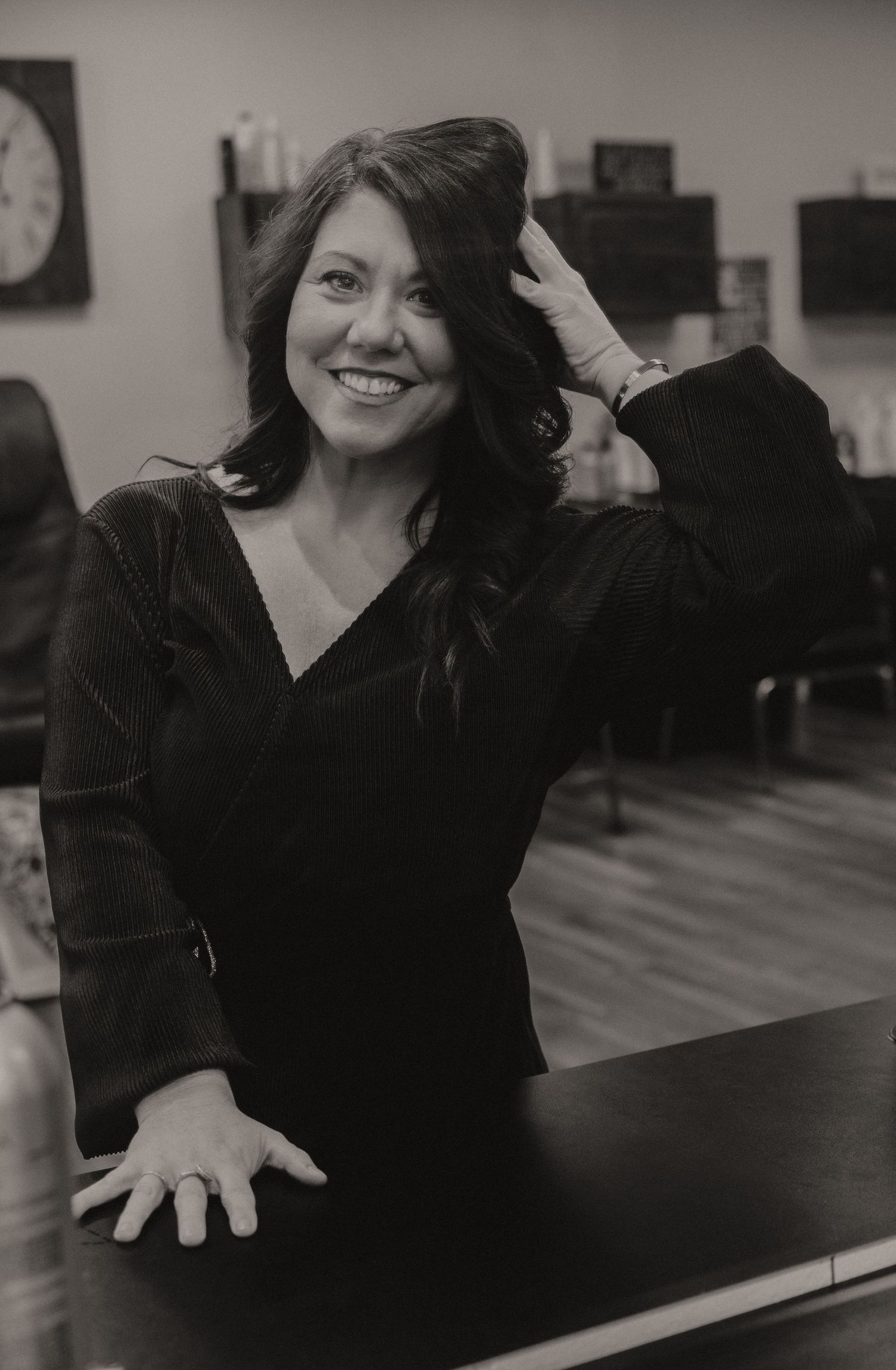 A black and white photo series showing a person in a dark sweater posing expressively at a piano.