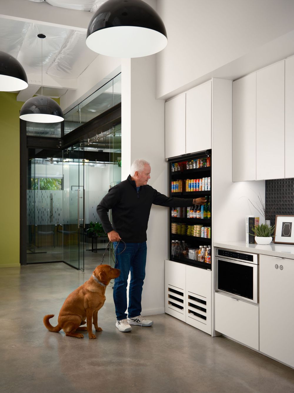 Office break area with built-in coffee station and employee interaction — workplace lifestyle photo by Khoi Ly.