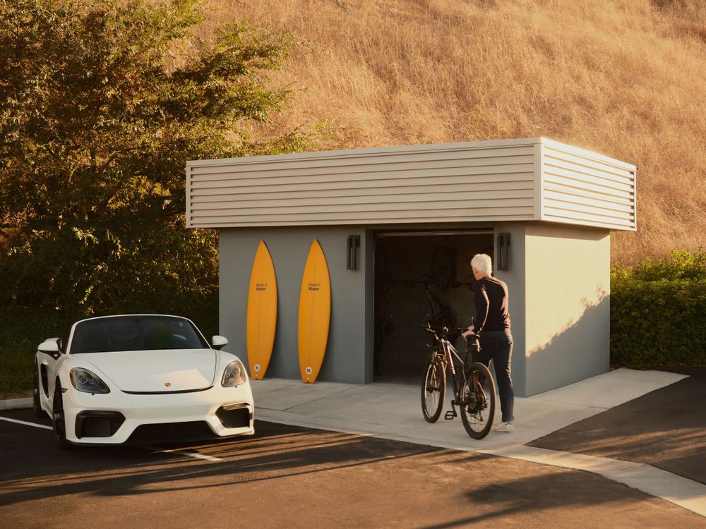 Active lifestyle vignette with cyclist, white car, and surf-themed storage unit — creative brand storytelling by Khoi Ly.