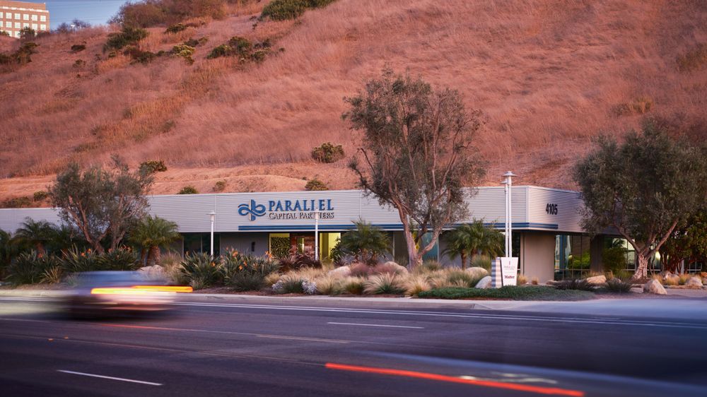 Exterior view of office building nestled in hillside with brand signage — commercial real estate photography by Khoi Ly.