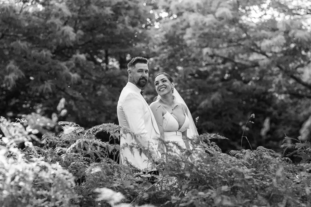A black and white photo collage shows intimate moments of a couple in an outdoor garden setting.