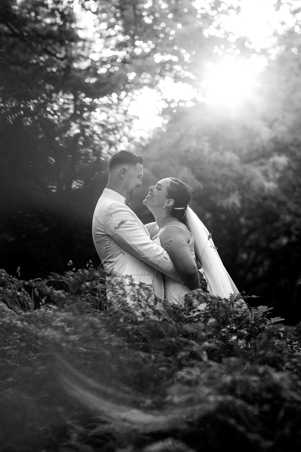 A black and white photo series shows someone lying in tall grass as sunlight filters through trees in a dreamy sequence.
