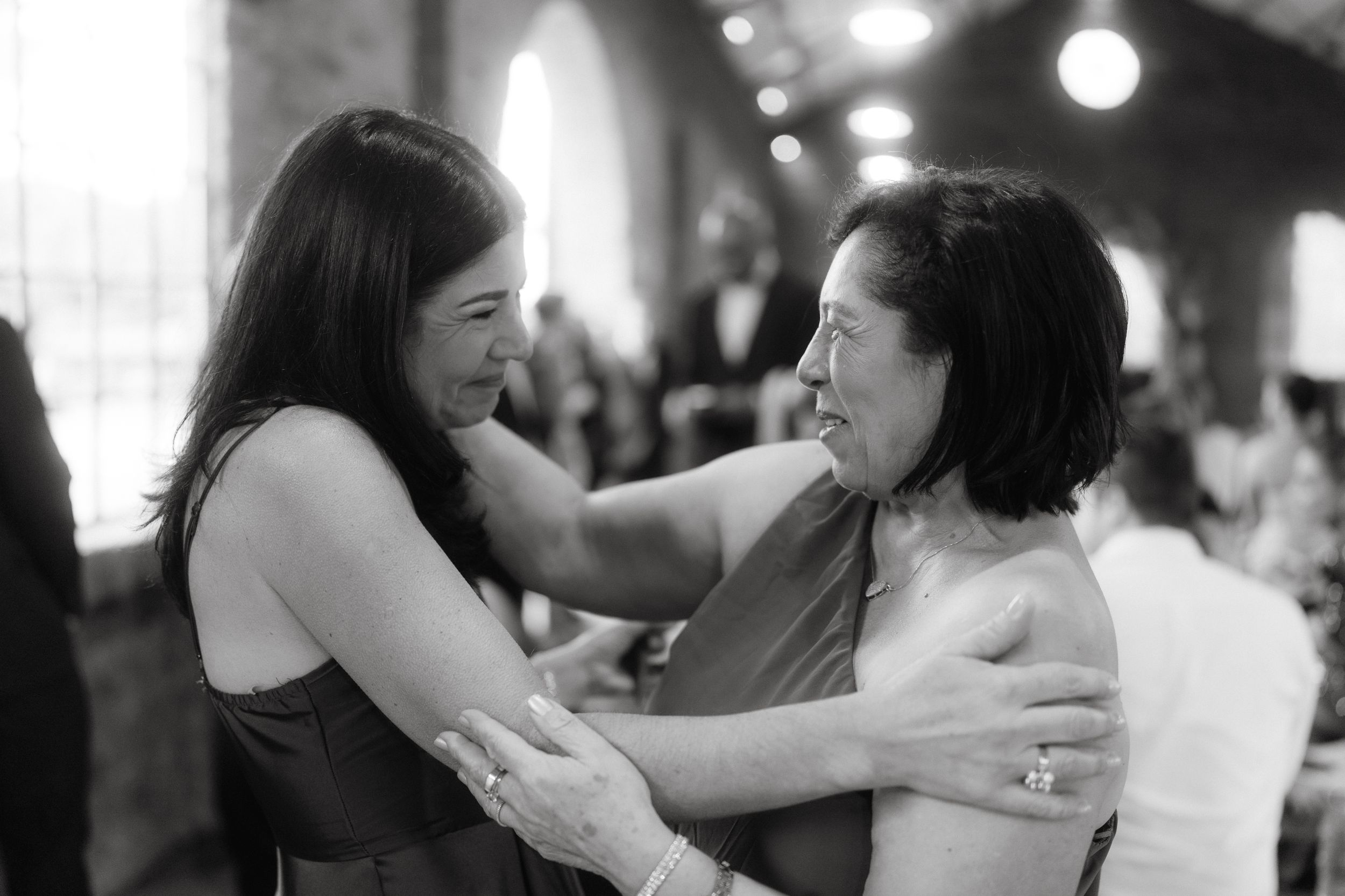 Guests dancing and celebrating at an indoor wedding reception.