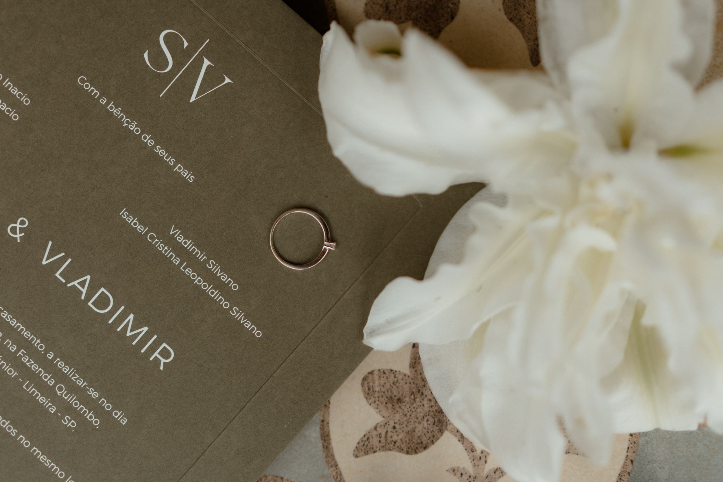 Close-up of elegant wedding invitation text on textured paper.