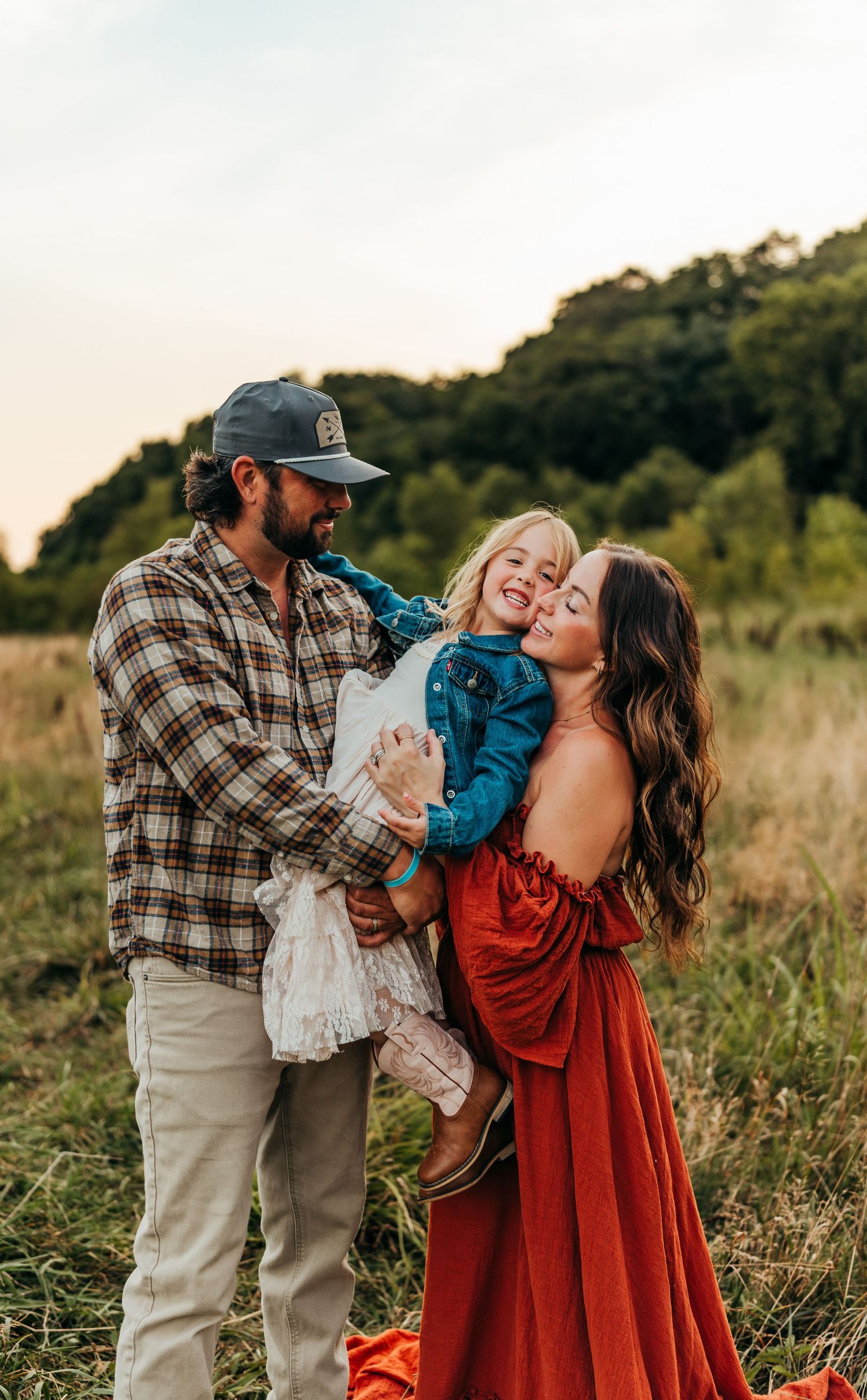 Family sharing joyful moment together in golden field at sunset in belvidere il