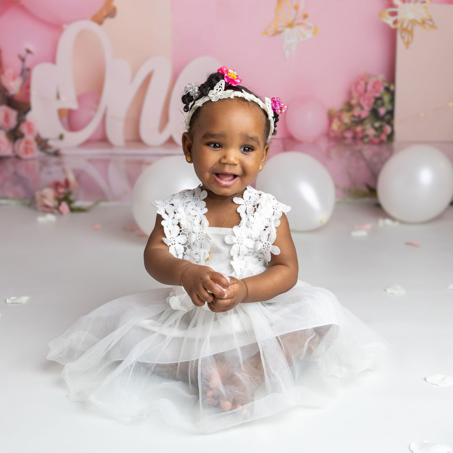 Picture of little girl smiling having fun at her cake smash photography session, cake smash & splash in Coventry.