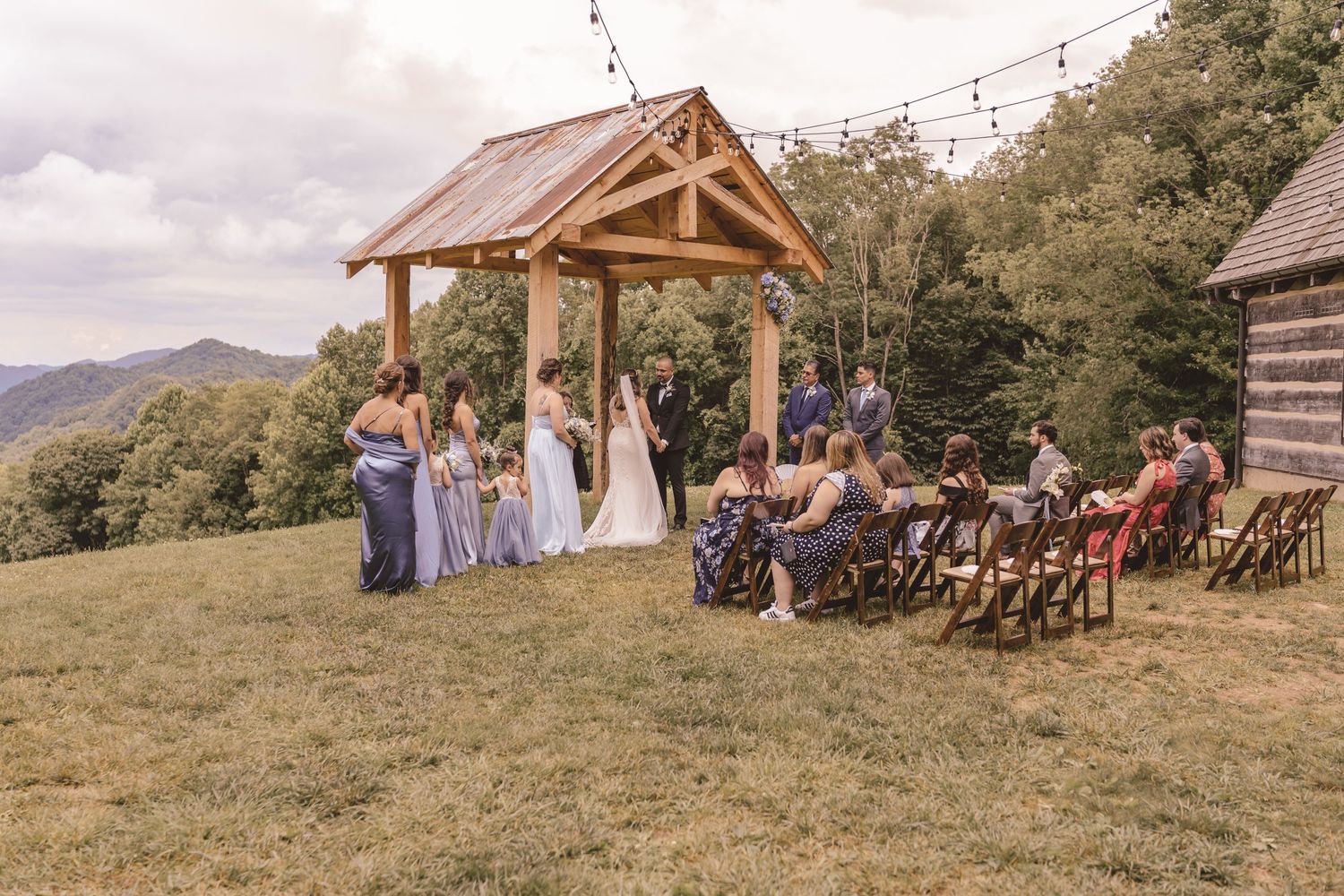 Side view of an outdoor wedding ceremony at The Heavens Venue in Hot Springs, NC