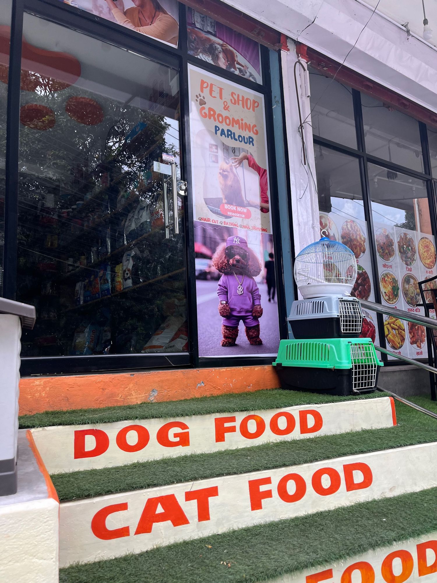 Pet store storefront with large red text advertising dog food and cat food on the exterior windows.