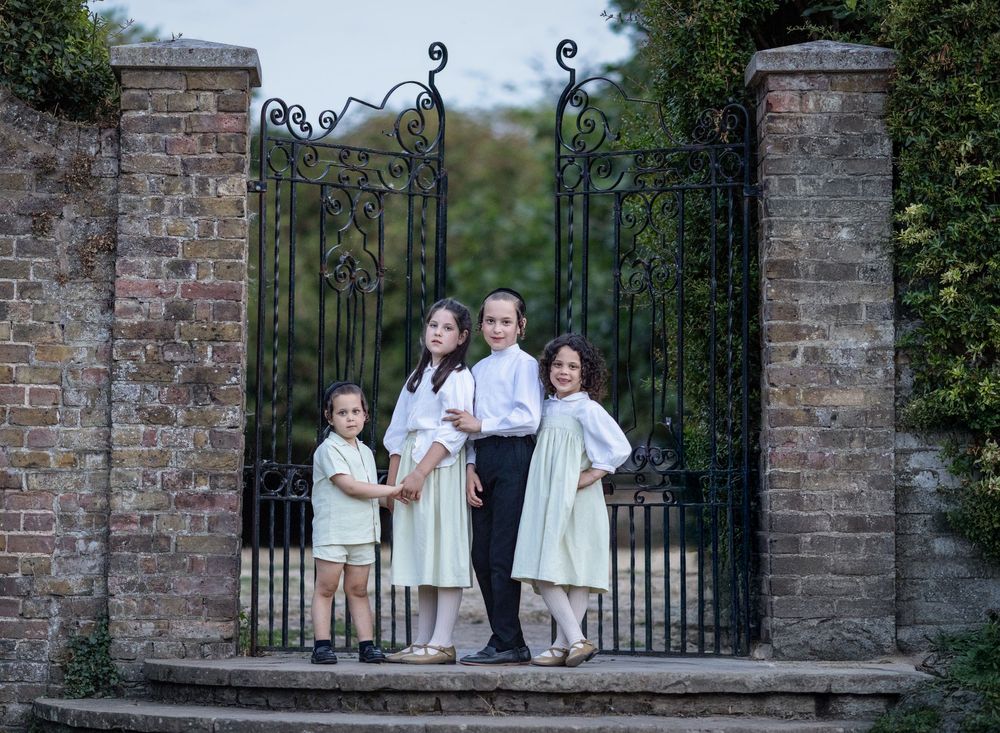 Kids standing by a gate.