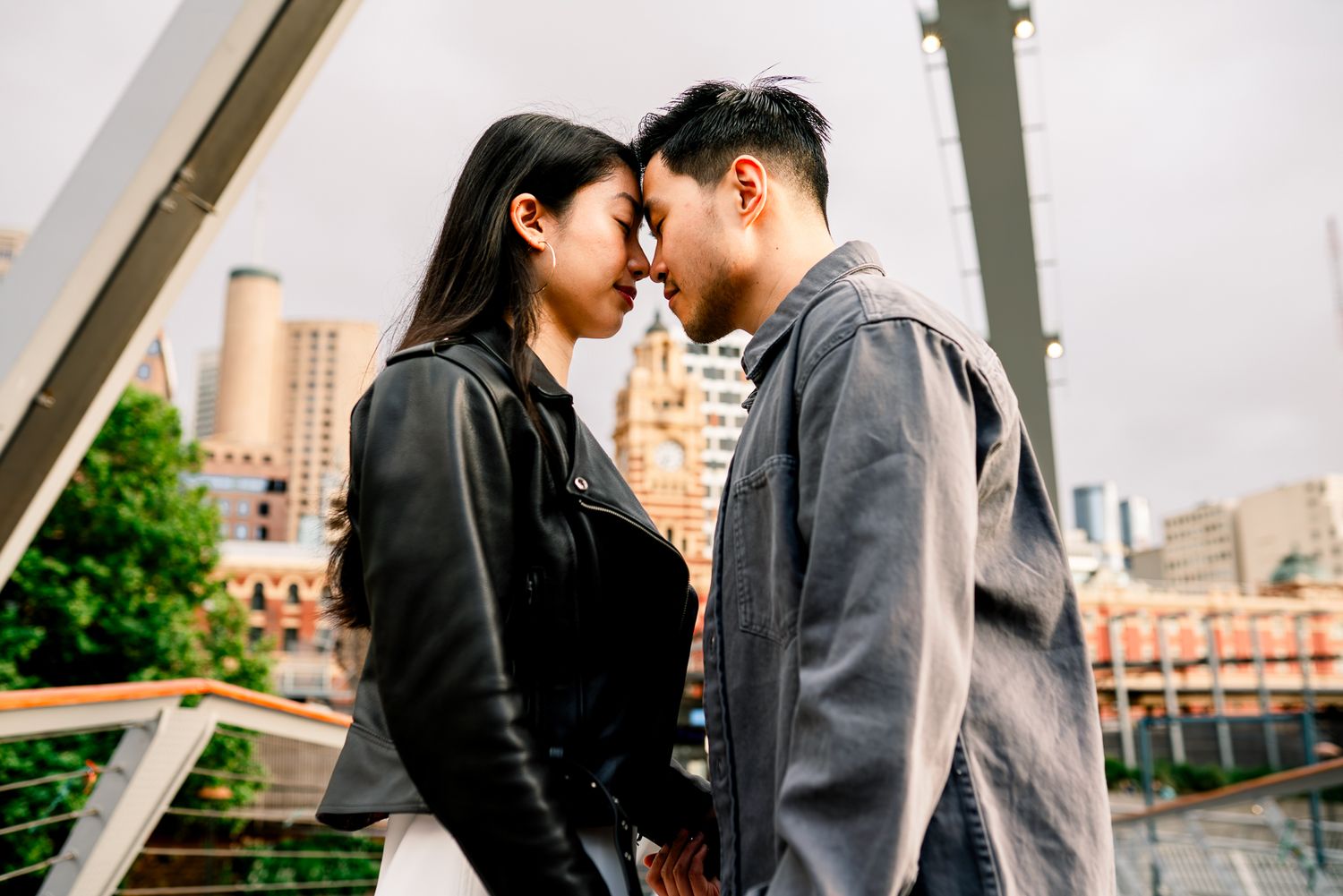 Melbourne photographer Pei A Photography capturing a casual couple with their foreheads touching for their engagement photos in the CBD