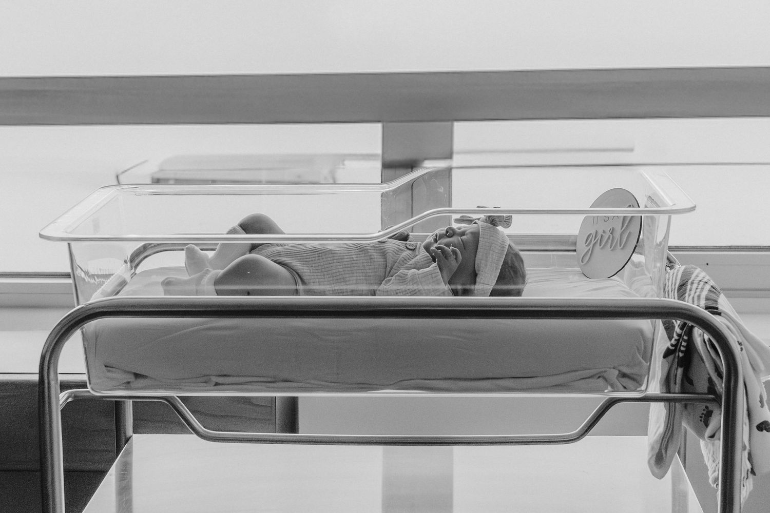 Vintage medical equipment and devices displayed on a metal hospital cart in black and white.