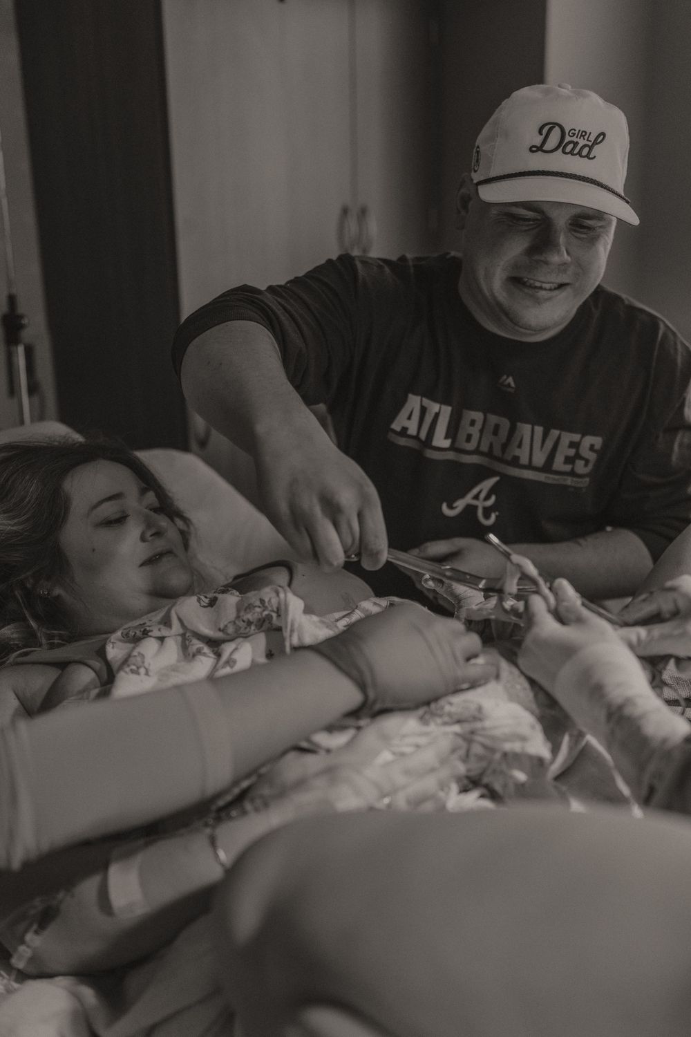 Emotional black and white hospital room scene with Atlanta Braves fan.