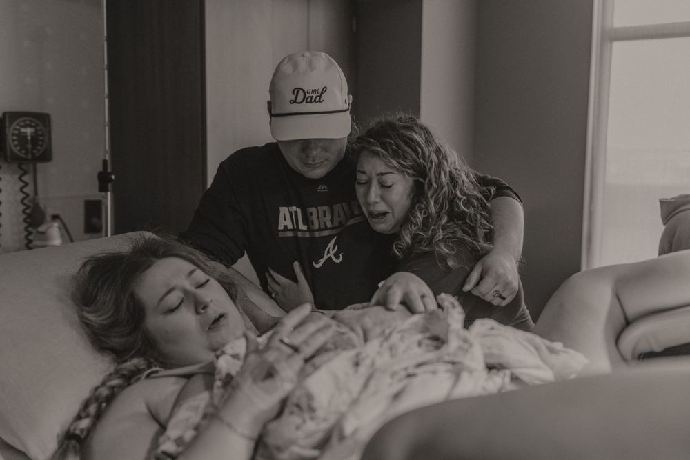 Black and white hospital birth photography sequence showing intimate moments during labor and delivery.