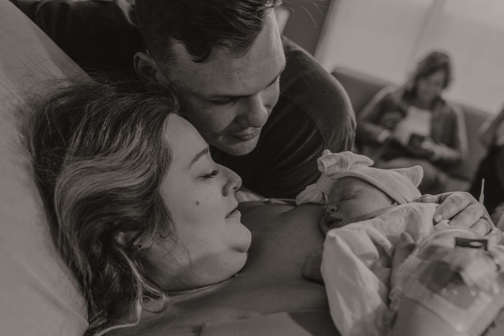 Emotional black and white birth photography sequence showing labor support and delivery.