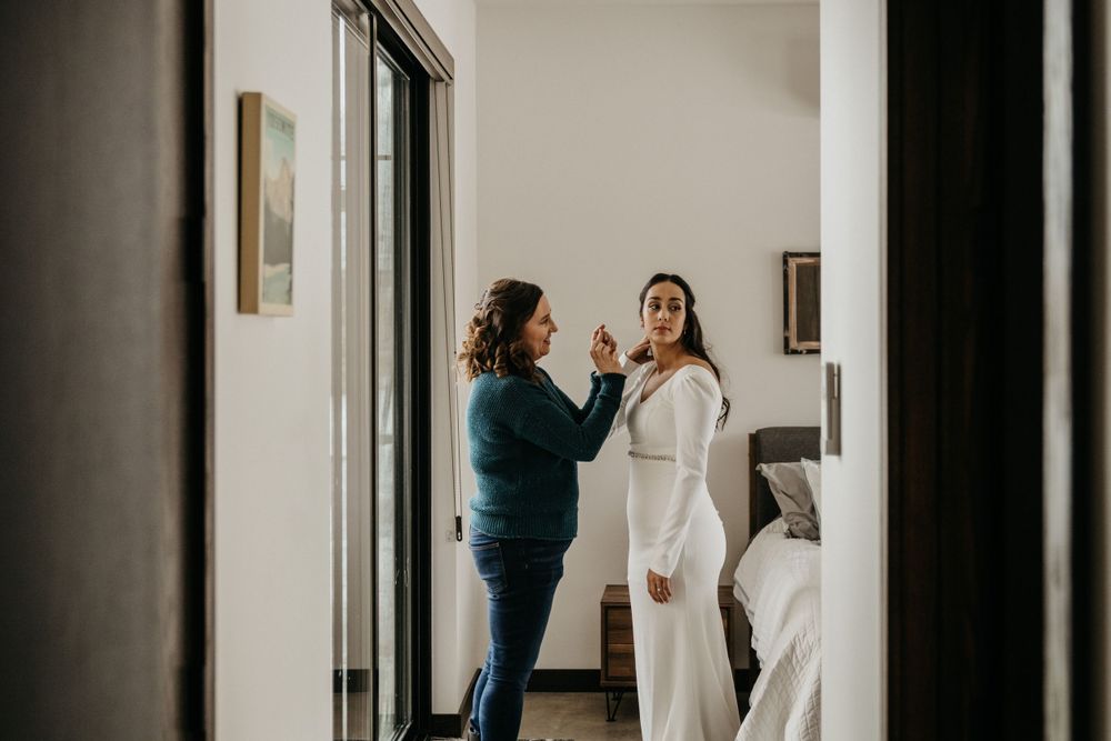 Getting ready scene from a wedding morning with white dress and preparations underway.