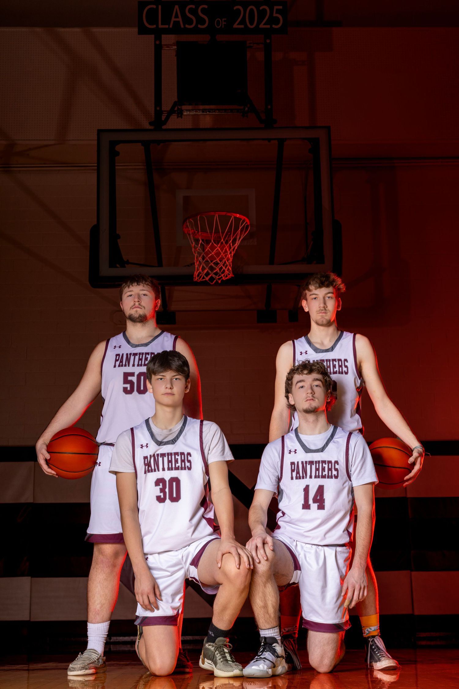A small basketball group poses for a sharp, confident portrait session, showcasing unity and team pride with focused expressions.