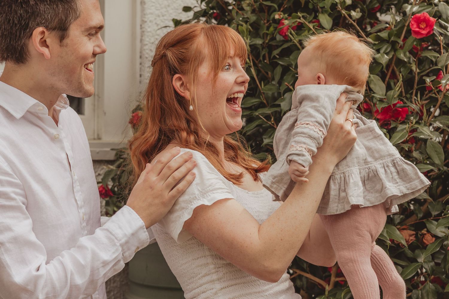 ginger family laughing with baby