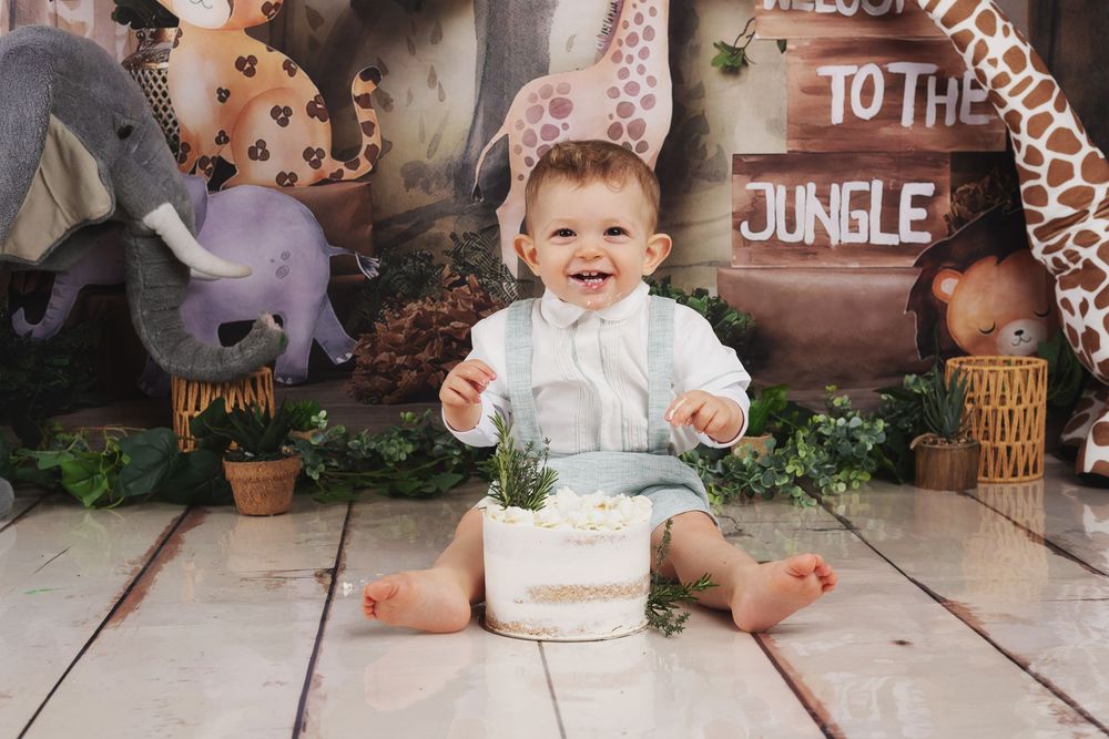 A series of connected photos showing a baby's first birthday cake smash session with safari-themed decorations and props.